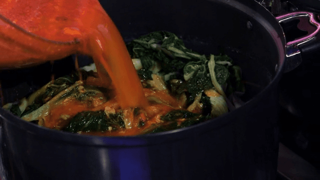 Putting seasoning broth in a pot with napa cabbage