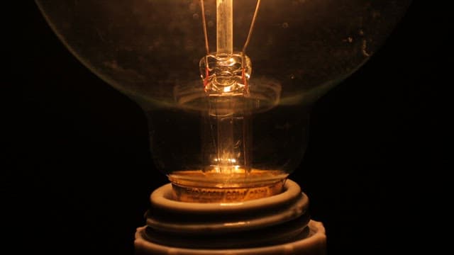 Filament of Light Bulb Heating up and Glowing