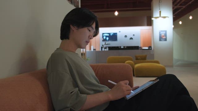 Man using a tablet on a sofa