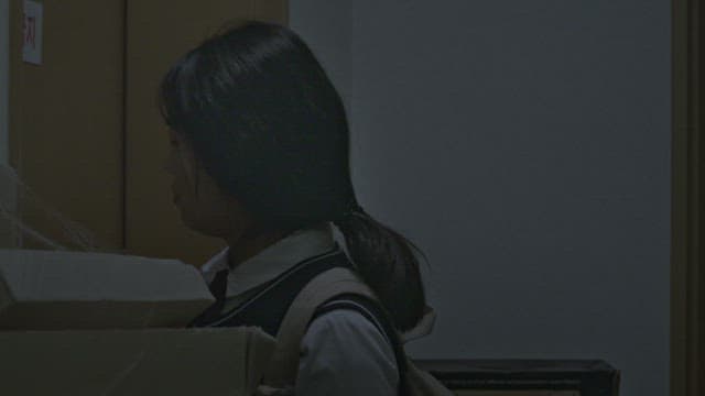 Female student irritated by locking the door in a dark room