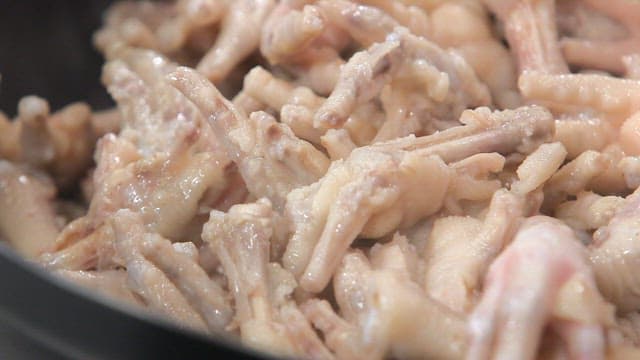 Prepared chicken feet on a frying pan