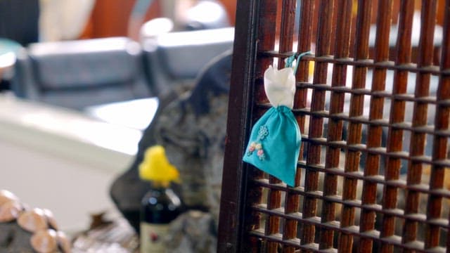 Traditional Korean bokjumeoni hanging on a lattice