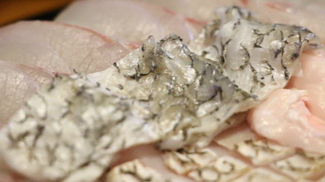 Bite of neatly plated fresh sashimi