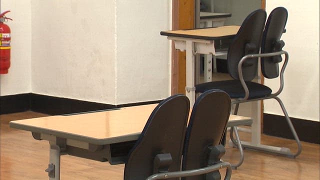 Empty Classroom with Desks and Chairs