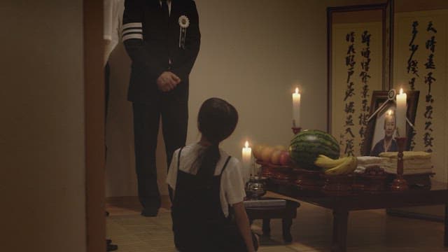 Families showing respect at a traditional Korean ancestral rite table