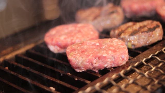 Grilled short rib patties grilled over fire