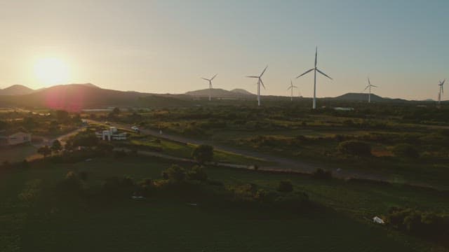 Wind turbines in a scenic landscape at sunset