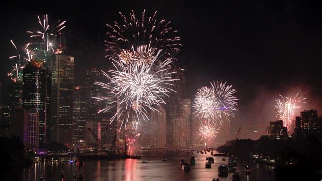 Fireworks display over a city skyline