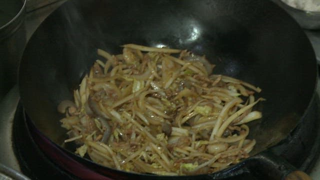 Stir-frying vegetables and meat in a wok