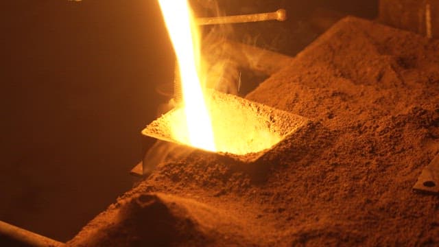 Molten metal being poured into a mold