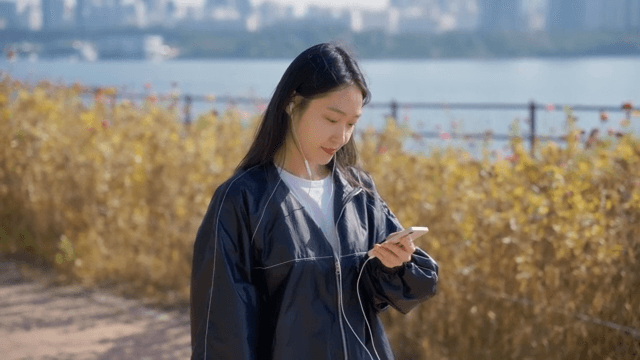 Woman listening to music by the river