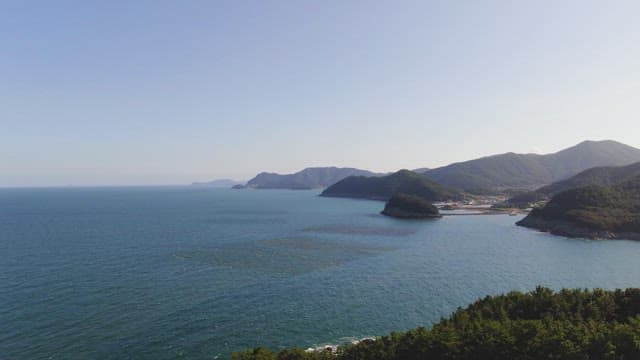Vast ocean with distant mountains