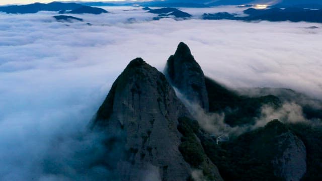 Majestic Mountains Rising Above Clouds