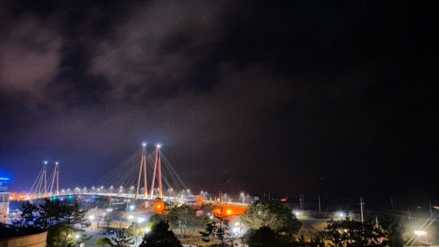 Brightly lit bridge at night