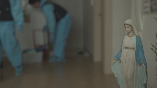Person walking around the house wearing a blue protective suit