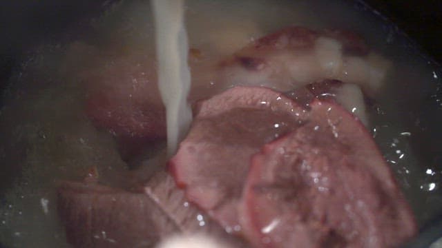Pouring Broth into Bowl of Seolleongtang with Meat