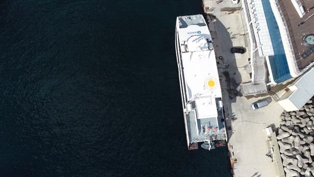 Ferry Terminal in Coastal Town and Docked Ships