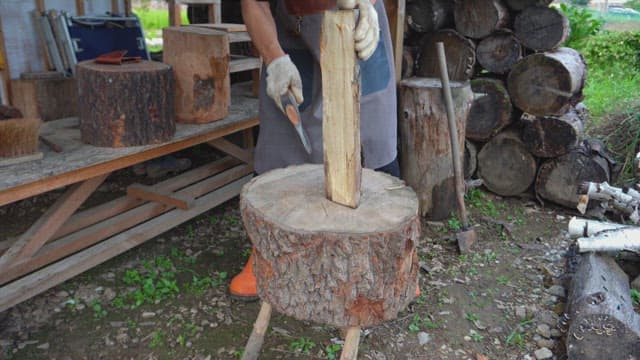 Person chopping wood with an axe
