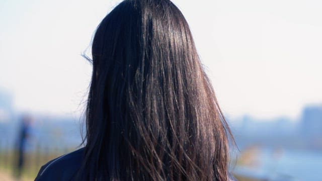 Woman tying her hair outdoors