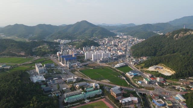 City surrounded by lush green mountains
