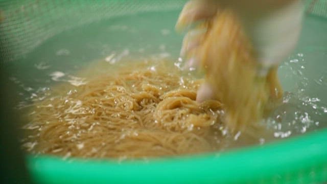 Preparing noodles in a commercial kitchen