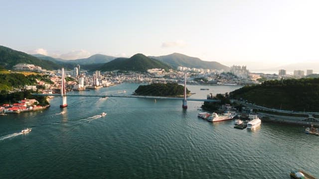 Coastal Cityscape with Bridge and Boats