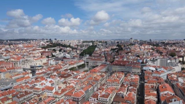 Quaint Town with Red Rooftops Under a Blue Sky