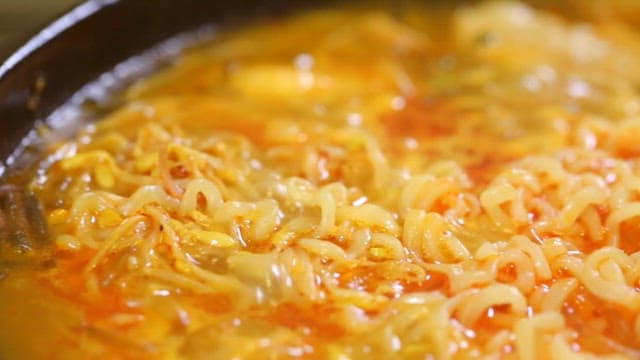 Boiling ramen noodles in a pot