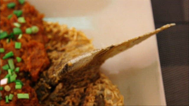 Fried Fish Topped with Sauce and Greens