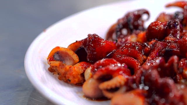 Delicious Glazed Octopus on a White Plate
