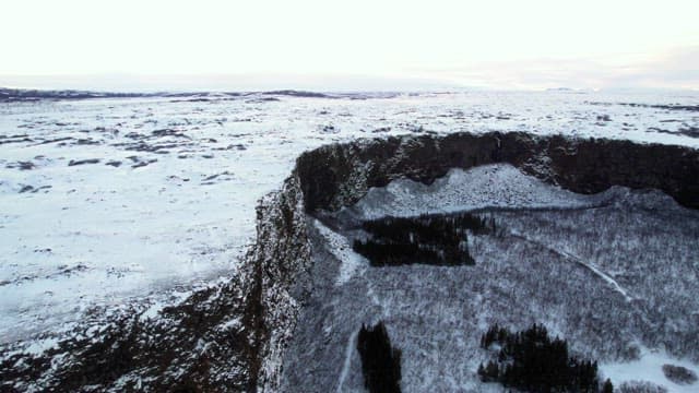 Snow-covered landscape with cliffs