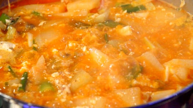 Spicy seafood stew boiling in a pot