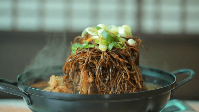 Pork backbone stew topped with sweet potato stem salad