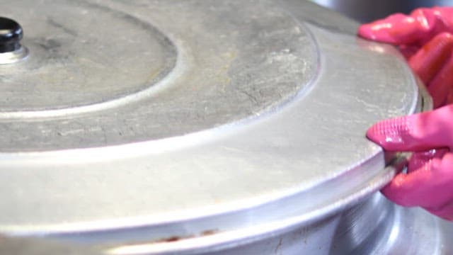 Boiling pig's feet in a large pot in the kitchen