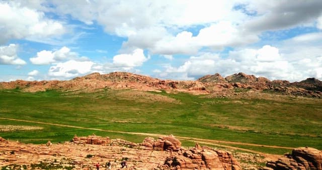 Rocky landscape with green fields