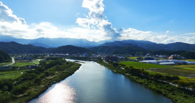 Scenic river flowing through lush fields
