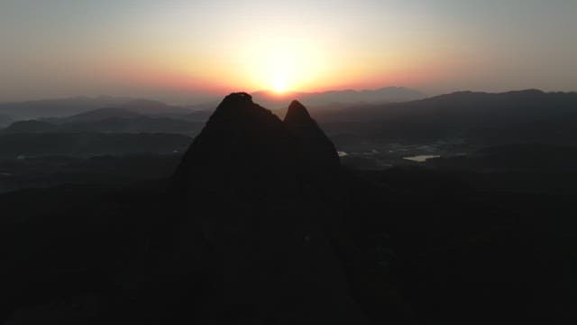 Dawning Sky and Silhouette of Majestic Mountain Peak