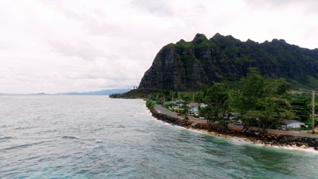Coastal Road Alongside Lush Green Mountain