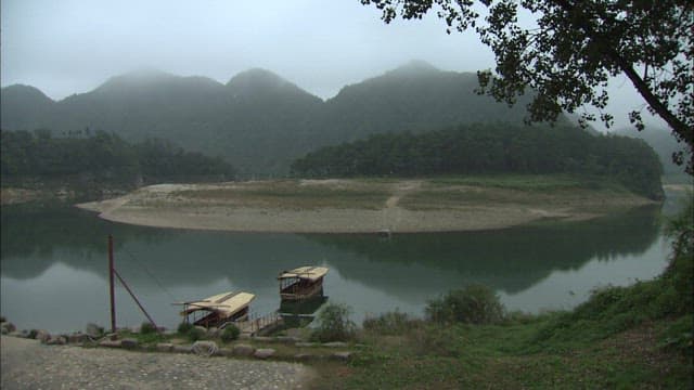 Serene Donggang River surrounded by misty mountains