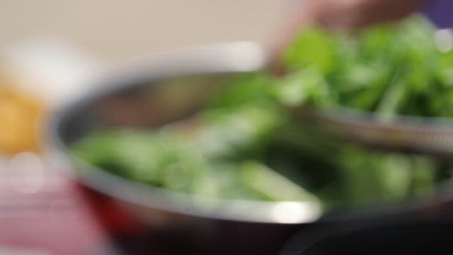 Fresh young radish leaves being prepared in a bowl