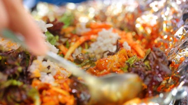 Stir-fried rice mixed with bean sprouts, pork bulgogi and lettuce