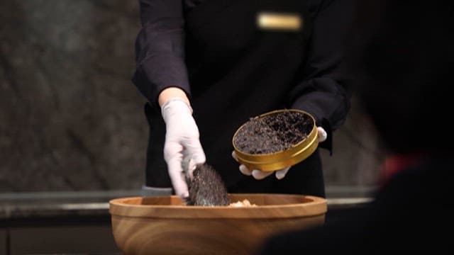 Preparing a Gourmet Dish with Caviar and Rice
