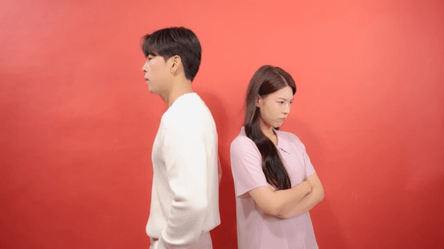 Man and a woman turning their backs on each other after an argument