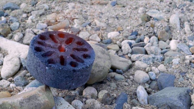 Burning briquettes lying on gravel