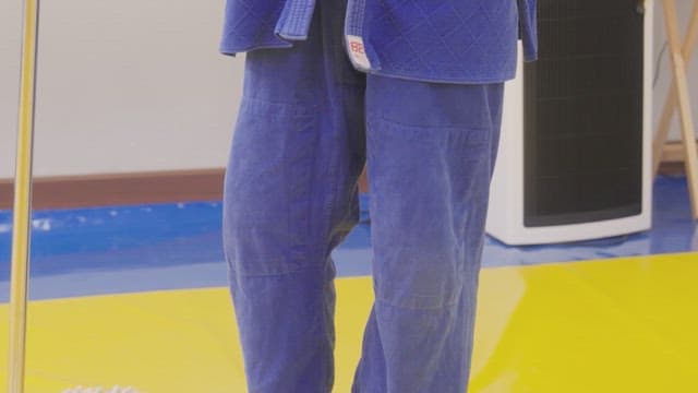 Man in a blue clothing for judo
