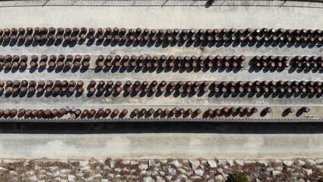 Traditional crocks arranged for fermentation in a large outdoor space