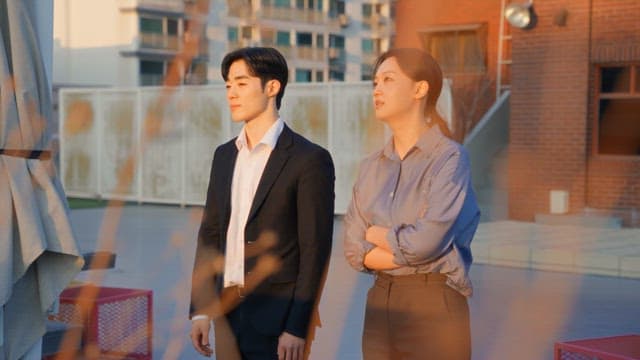 Two people talking on a rooftop