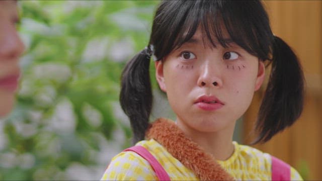 Girl with pigtails lost in thought during a conversation