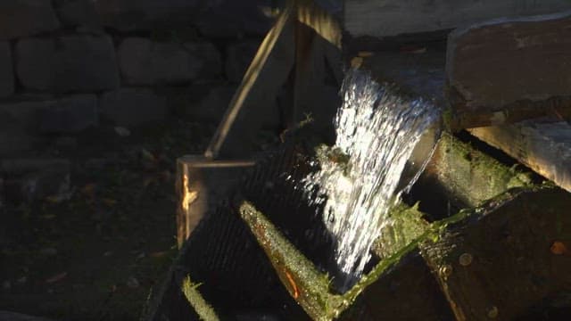 Watermill Rotating Along the Falling Water