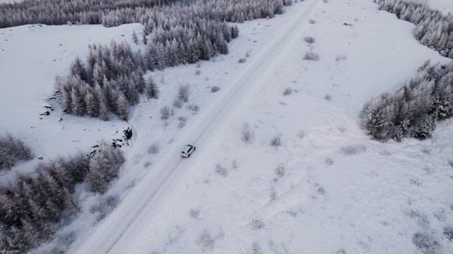 Car driving through a snowy landscape